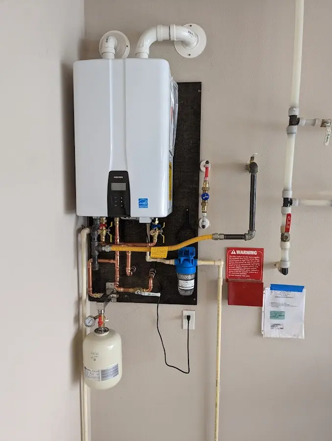 Professional plumber installing copper piping in a New Port Richey home